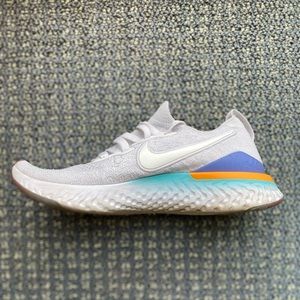 White and multicolor nike fly knit shoes